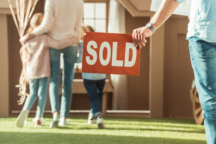 Successful Home Sale in Pensacola Real estate agent in Pensacola helping homeowners successfully sell their property with a SOLD sign.