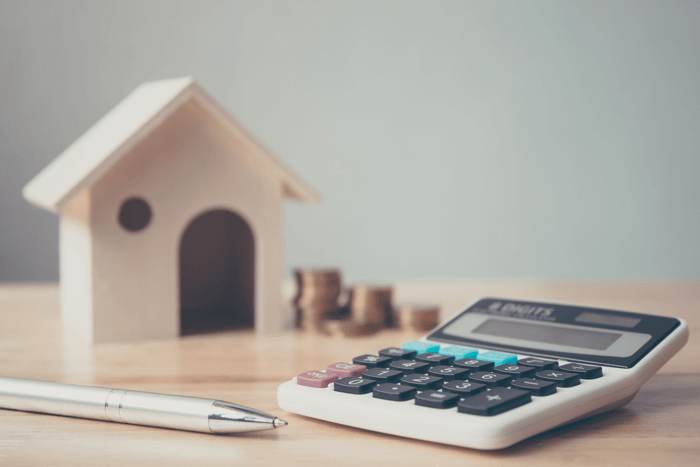 Buy a home in Pensacola – mortgage calculator, coins, and house model for budgeting