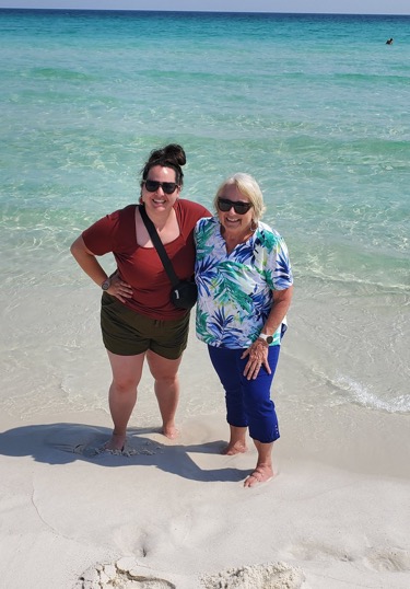 Karen Schwan, real estate agent in Pensacola, enjoying the beach with a client in Florida.